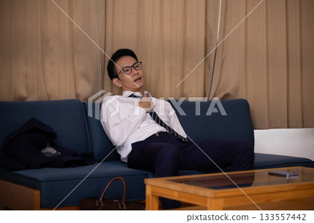 A man returning home tired from work 133557442