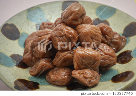 A mountain of pickled plums on a plate 133557740