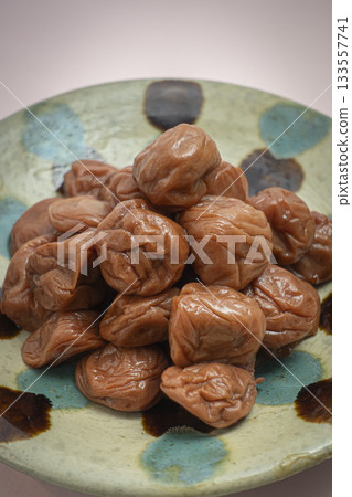 A mountain of pickled plums on a plate 133557741