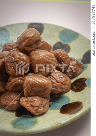 A mountain of pickled plums on a plate 133557742