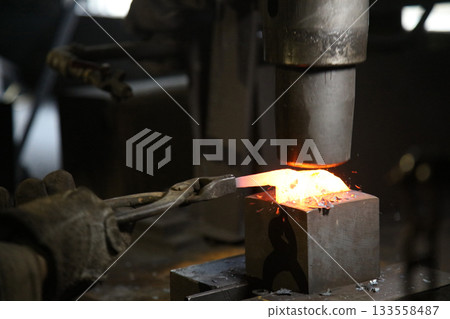A craftsman who hammers heated materials into shapes 133558487