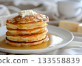 Delicious pancakes with syrup and butter are a comforting breakfast or brunch treat 133558839