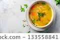 A bowl of homemade chicken soup with veggies and herbs is comforting, healthy, and nourishing 133558841