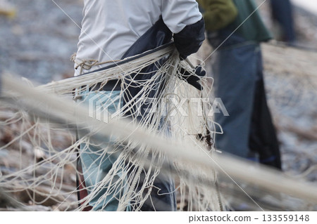 Fisherman clearing his net Fisherman clearing his net 133559148