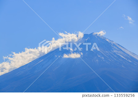 Snow covered Mt. Fuji that shines in the blue sky Snow covered Mt. Fuji that shines in the blue sky 133559256
