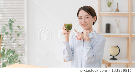 A woman drinking green juice (banner) A woman drinking green juice (banner) 133559815
