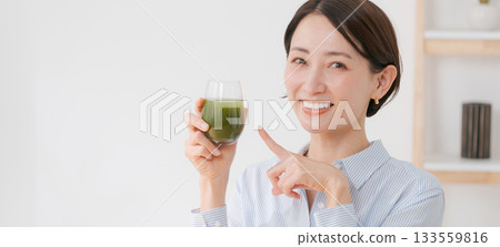 A woman drinking green juice (banner) A woman drinking green juice (banner) 133559816