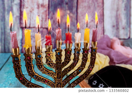 Warm lighting menorah features candles lit for Hanukkah, celebration festive atmosphere Warm lighting menorah features candles lit for Hanukkah, celebration festive atmosphere 133560802