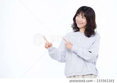 Smiling woman pointing up her index finger Smiling woman pointing up her index finger 133561163