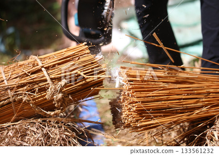A man cutting thatch A man cutting thatch 133561232
