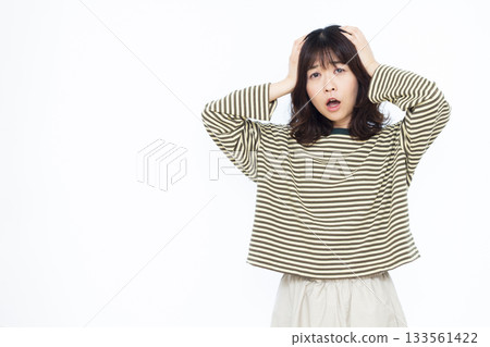 Surprised woman holding her head 133561422