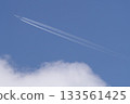 An airplane cloud extending into the blue sky 133561425