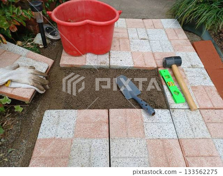 A housewife steadily builds a garden by herself♪ Laying paving stones in the garden 133562275