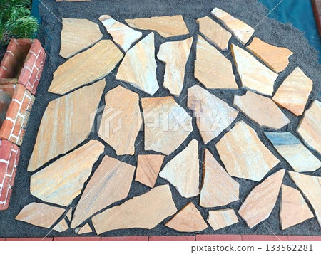 A housewife steadily builds a garden by herself♪ Laying paving stones in the garden 133562281
