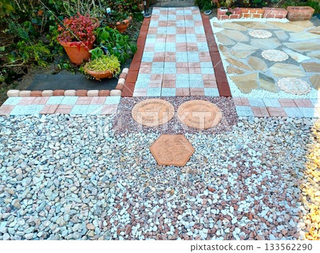 A housewife steadily builds a garden by herself♪ Laying paving stones in the garden 133562290