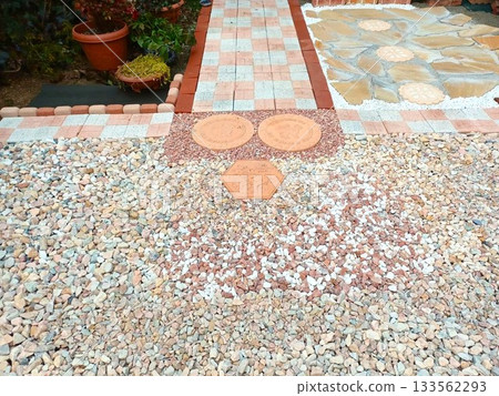 A housewife steadily builds a garden by herself♪ Laying paving stones in the garden A housewife steadily builds a garden by herself♪ Laying paving stones in the garden 133562293