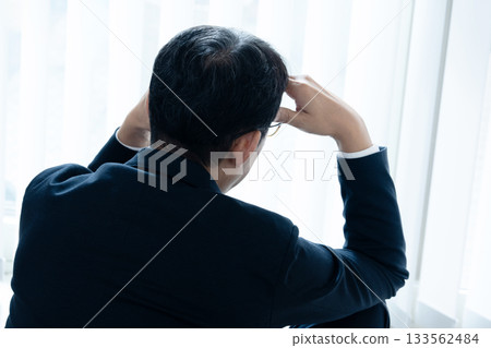 Depressed middle-aged businessman Depressed middle-aged businessman 133562484