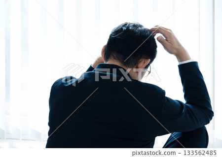 Depressed middle-aged businessman Depressed middle-aged businessman 133562485
