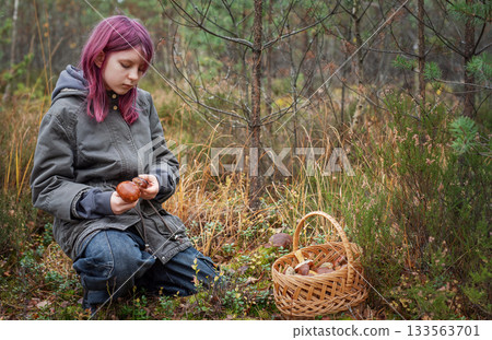 Young girl foraging mushroom in autumn forest picking 133563701