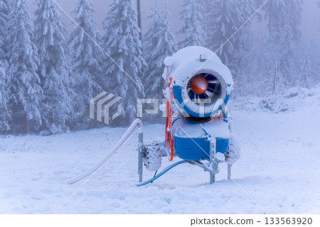 Snow gun or snow cannon in winter ski resort. Turned off snowmaking machine in snowy winter time Snow gun or snow cannon in winter ski resort. Turned off snowmaking machine in snowy winter time 133563920