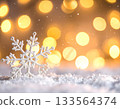 Macro Snowflake on Snow with Golden Christmas Bokeh Lights 133564374