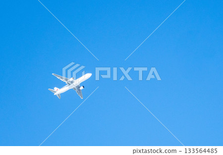 A simple scene of a blue sky and an airplane heading to its destination 133564485