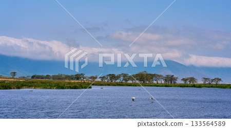 View of Lake Ngorongoro and the outer rim of the crater with clouds passing by View of Lake Ngorongoro and the outer rim of the crater with clouds passing by 133564589