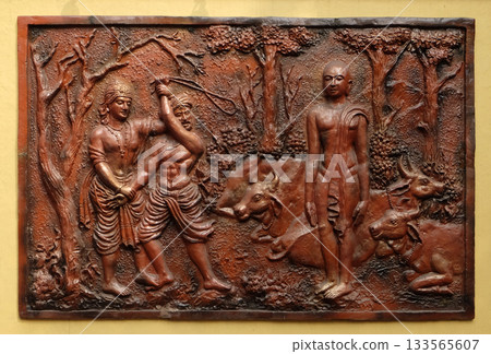 Indra prevents an ignorant cowherd from assaulting Bhagavan Mahavira, Street bass relief on the wall of Jain Temple (also called Parshwanath Temple) in Kolkata, West Bengal, India 133565607