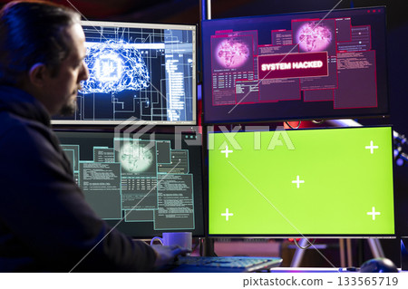 Hacker getting system hacked popup alert on green screen mockup computer after using malware software. Rogue engineer at home using chroma key PC to hide online activity after stealing data 133565719