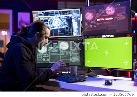 Hacker doing covert operations using AI on isolated screen PC to bypass advanced security. Rogue programmer engineering data theft script to penetrate firewalls using chroma key computer Hacker doing covert operations using AI on isolated screen PC to bypass advanced security. Rogue programmer engineering data theft script to penetrate firewalls using chroma key computer 133565769