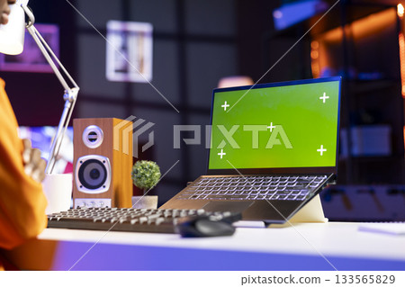 Remote employee in home office editing documents on chroma key laptop, updating reports and files, typing. Close up of isolated screen notebook used by person managing digital paperwork 133565829