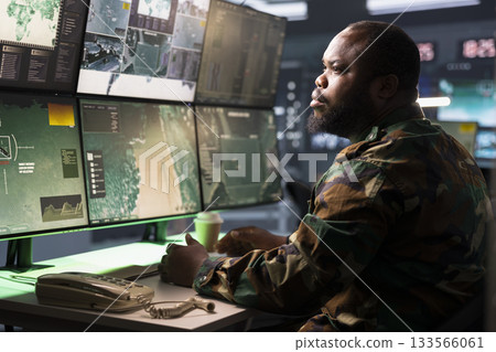 Counterintelligence agent in command center combating terrorism using detection system. Intelligence agency officer protecting national borders by tracking terrorists entering country 133566061