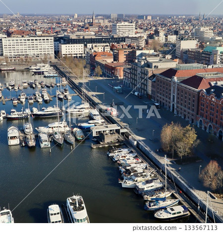 Antwerp city waterfront marina aerial view, boats moored along the docks, historic architecture in background 133567113