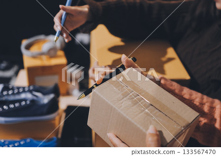 Asian woman describe selling clothes on camera live broadcast on social network at home, Online selling clothes on social media. Blogger woman influencer, SME retail store owner. Asian woman describe selling clothes on camera live broadcast on social network at home, Online selling clothes on social media. Blogger woman influencer, SME retail store owner. 133567470