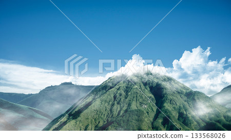 Landscape view of a mountain with cloudscapes against a blue sky background. Natural background 133568026