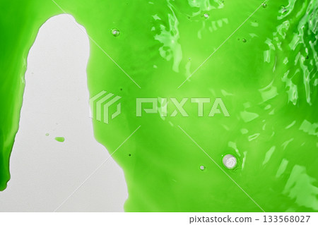 Closeup view of vibrant green liquid. Creating a refreshing and dynamic abstract background 133568027