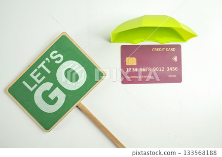 Top view of debit or credit card with green umbrella and green signboard with Let's go text on a white background. Mockup or template. Flat lay. Concept of Security, finance, and business Top view of debit or credit card with green umbrella and green signboard with Let's go text on a white background. Mockup or template. Flat lay. Concept of Security, finance, and business 133568188