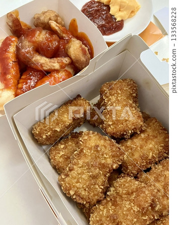 Crispy Korean fried chicken, perfectly glazed with a sweet and spicy sauce. Ideal for food photography and menus, showcasing the irresistible crunch and flavor of this beloved dish. Crispy Korean fried chicken, perfectly glazed with a sweet and spicy sauce. Ideal for food photography and menus, showcasing the irresistible crunch and flavor of this beloved dish. 133568228