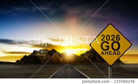 Street toward the hills with a yellow signboard with a greeting of 2026 Go Ahead. Happy New Year concept or Celebration 133568236