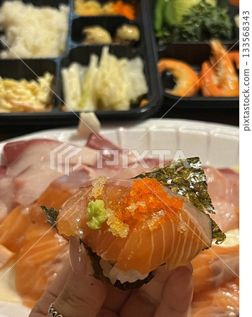An assortment of fresh sushi, artfully arranged with a variety of toppings and vibrant colors. This traditional Japanese dish combines vinegared rice, seafood, and vegetables for an experience. An assortment of fresh sushi, artfully arranged with a variety of toppings and vibrant colors. This traditional Japanese dish combines vinegared rice, seafood, and vegetables for an experience. 133568343