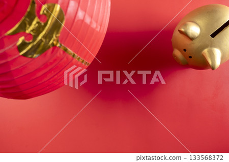 Red Chinese lantern with piggy bank on a red background. Mockup, template, or copy space. Decoration for the Lunar or Chinese New Year celebration Red Chinese lantern with piggy bank on a red background. Mockup, template, or copy space. Decoration for the Lunar or Chinese New Year celebration 133568372
