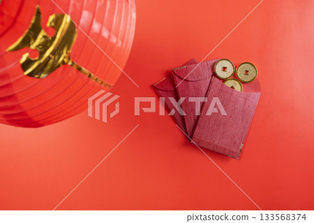 Red Chinese lantern with red envelopes or angpao and golden Chinese coins on a red background. Mockup, template, or copy space. Decoration for the Lunar or Chinese New Year celebration Red Chinese lantern with red envelopes or angpao and golden Chinese coins on a red background. Mockup, template, or copy space. Decoration for the Lunar or Chinese New Year celebration 133568374