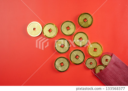 Red envelopes or angpao and golden Chinese coins on a red background. Mockup, template, or copy space. Decoration for the Lunar or Chinese New Year celebration 133568377