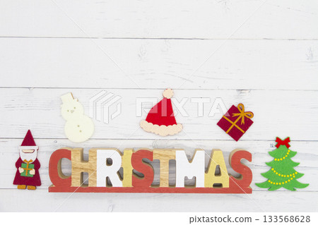 The word "CHRISTMAS" and Christmas decorations placed on a white wooden background The word "CHRISTMAS" and Christmas decorations placed on a white wooden background 133568628
