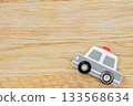 Wooden background and miniature police car 133568634
