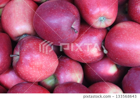 Ripe red apples creating a vibrant healthy background 133568643