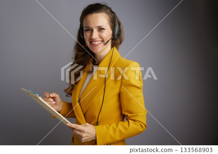 Businesswoman with Headset, Clipboard and Pen 133568903