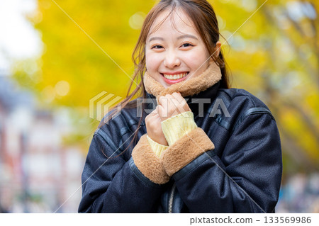 身穿外套的微笑年輕女子 133569986