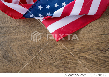 United States flag on wooden backdrop with copy space, great for banners, posters, and digital designs for patriotic events such as Independence Day, Veterans Day, Labor Day,Memorial Day. 133570512