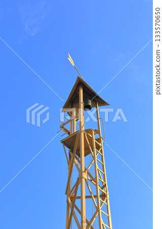 A fire tower that shines against the blue sky 133570650